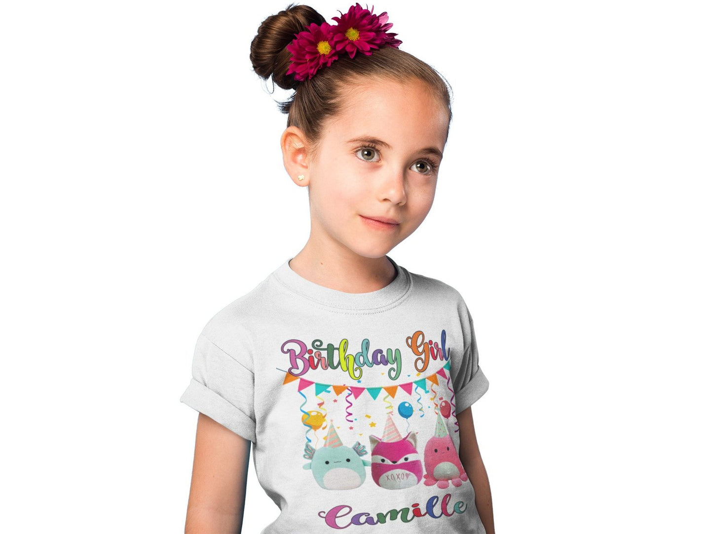 A girl modeling a Squishmallows birthday shirt with 3 squishmallows